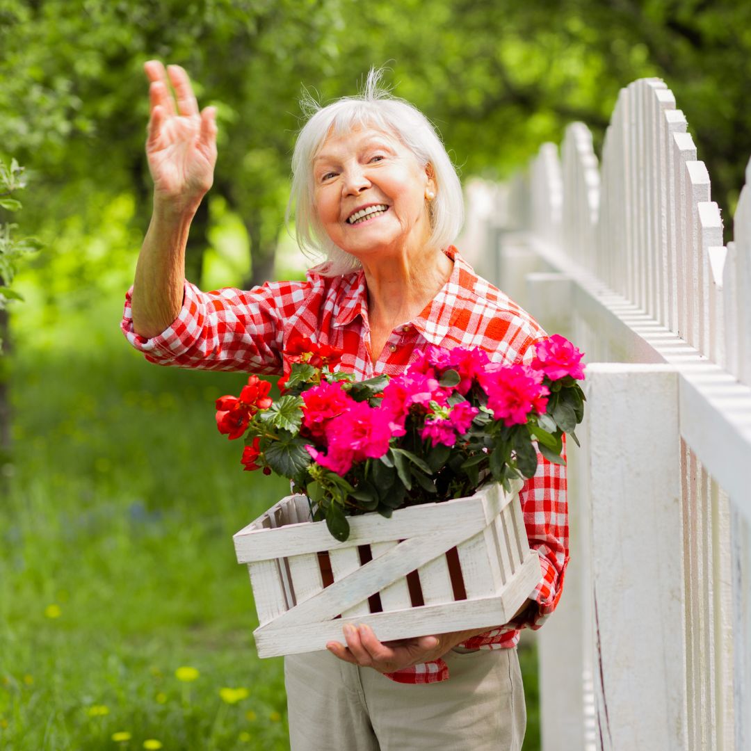 woman waving and holding flowers
