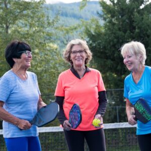 senior women playing pickleball