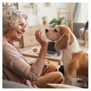 A women giving her a dog a treat