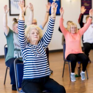 seniors exercising in chairs