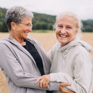 senior friends holding hands