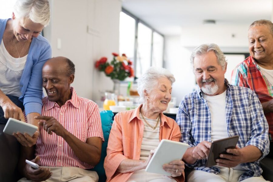 a group of people smiling and laughing reviewing senior living options